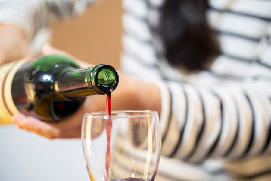 Person Pouring Wine